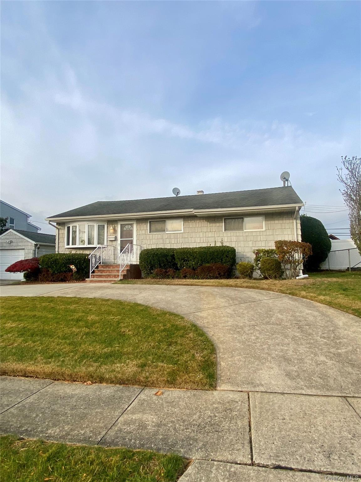 816 Anderson Avenue Franklin Square, NY 11010 - Photo 2 of 11 a front view of a house with a garden and porch