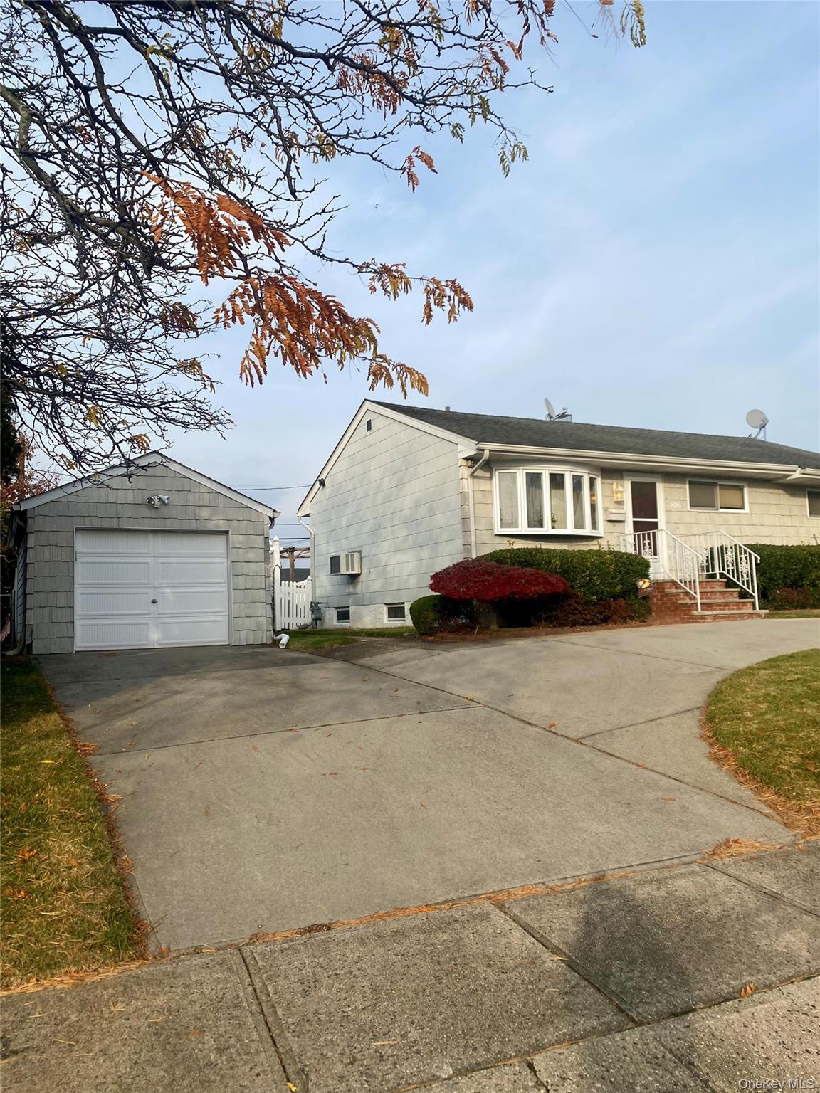 816 Anderson Avenue Franklin Square, NY 11010 - Photo 3 of 11 a view of parking space and a car park in front of house