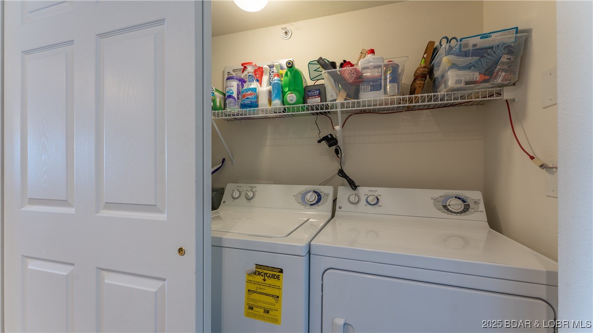 108 Park Pl Drive, Unit 1B Kaiser, MO 65047 - Photo 11 of 28 Utility closet with Washer, Dryer and Storage.
