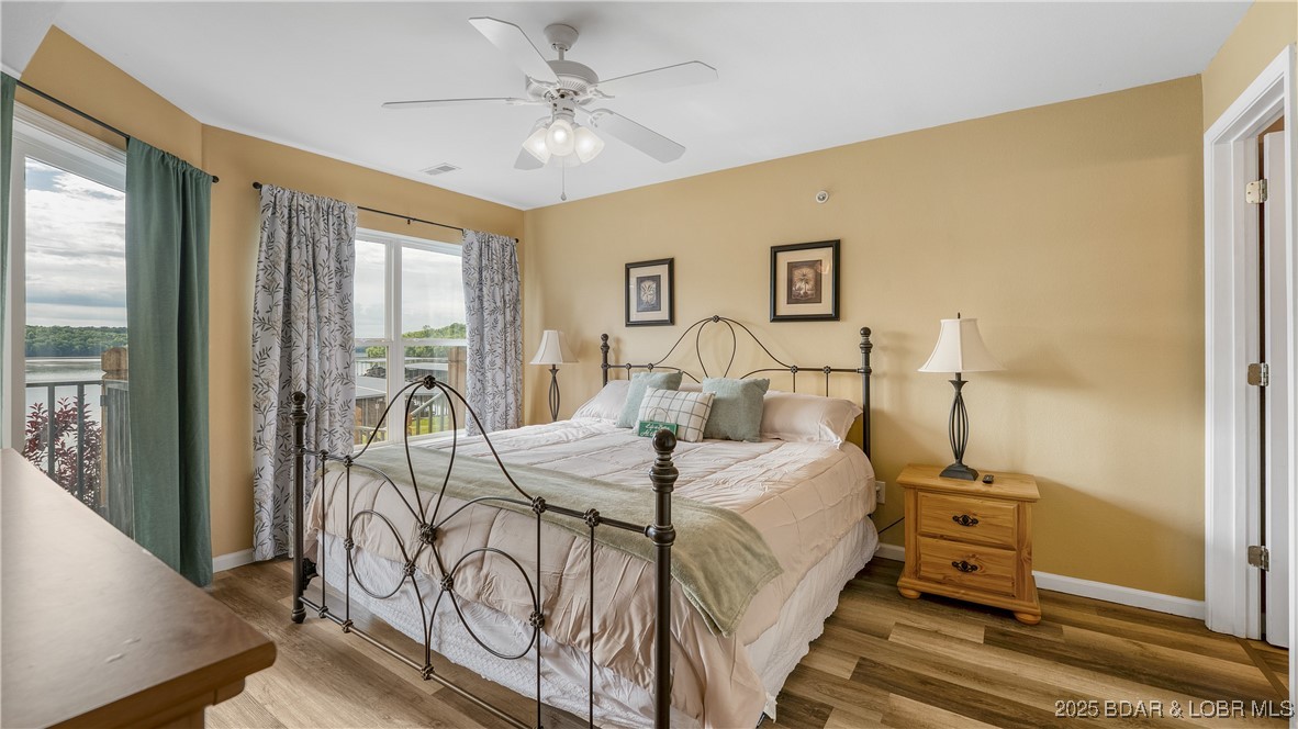 108 Park Pl Drive, Unit 1B Kaiser, MO 65047 - Photo 15 of 28 Primary Suite with King Bed and Walk-in Closet.