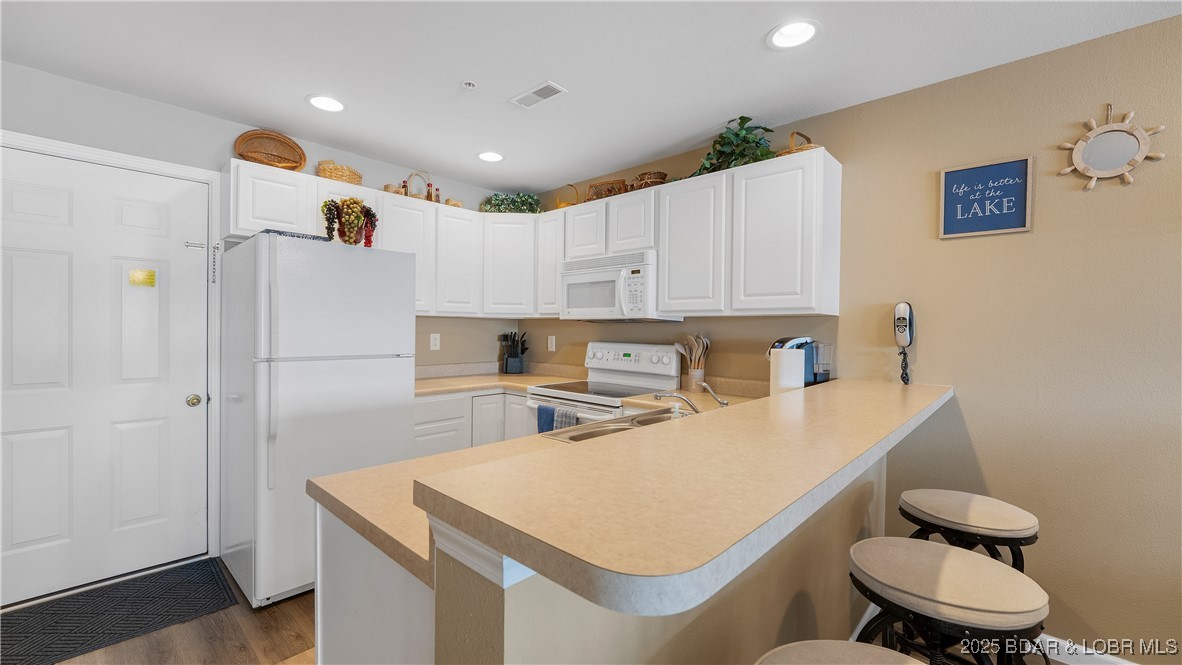108 Park Pl Drive, Unit 1B Kaiser, MO 65047 - Photo 8 of 28 Breakfast Bar perfect for lake day buffets.