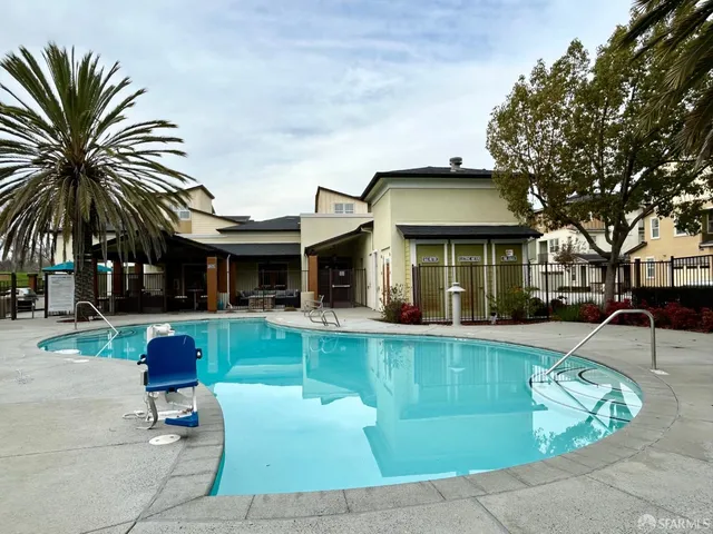 a living room with furniture and floor to ceiling windows