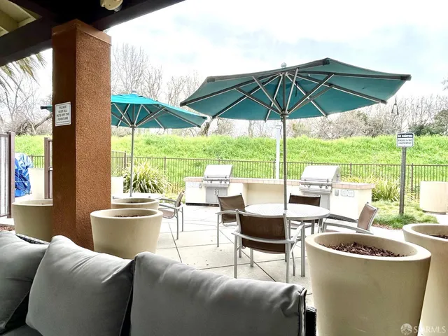 a view of a patio with a table and chairs