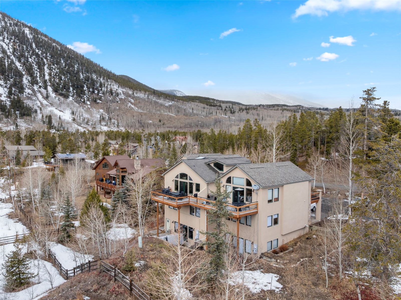 14 Larson Lane, Unit B Frisco, CO 80443 - Photo 2 of 40 a view of a big house with a mountain in the background