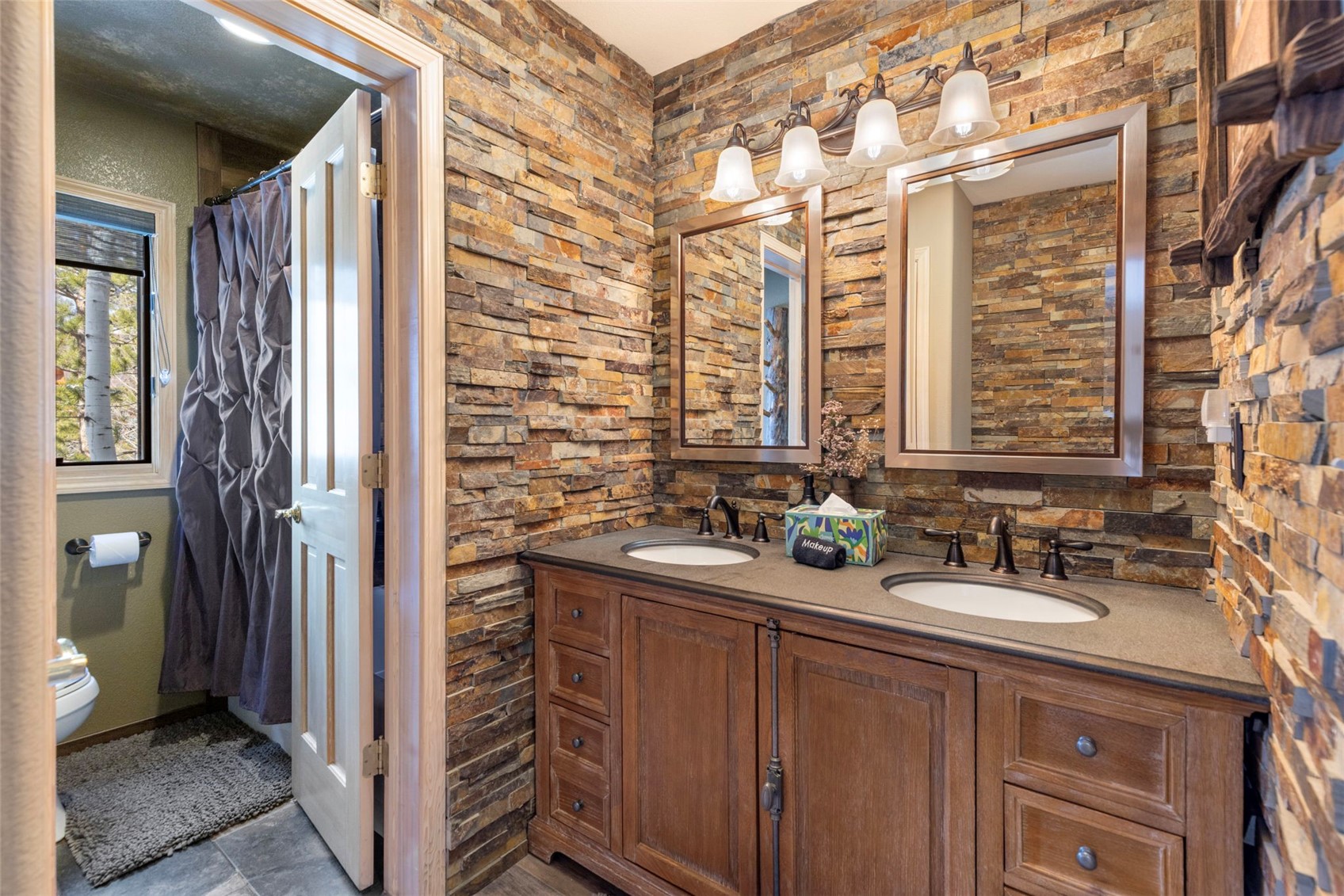 14 Larson Lane, Unit B Frisco, CO 80443 - Photo 22 of 40 a bathroom with a sink a mirror and a shower