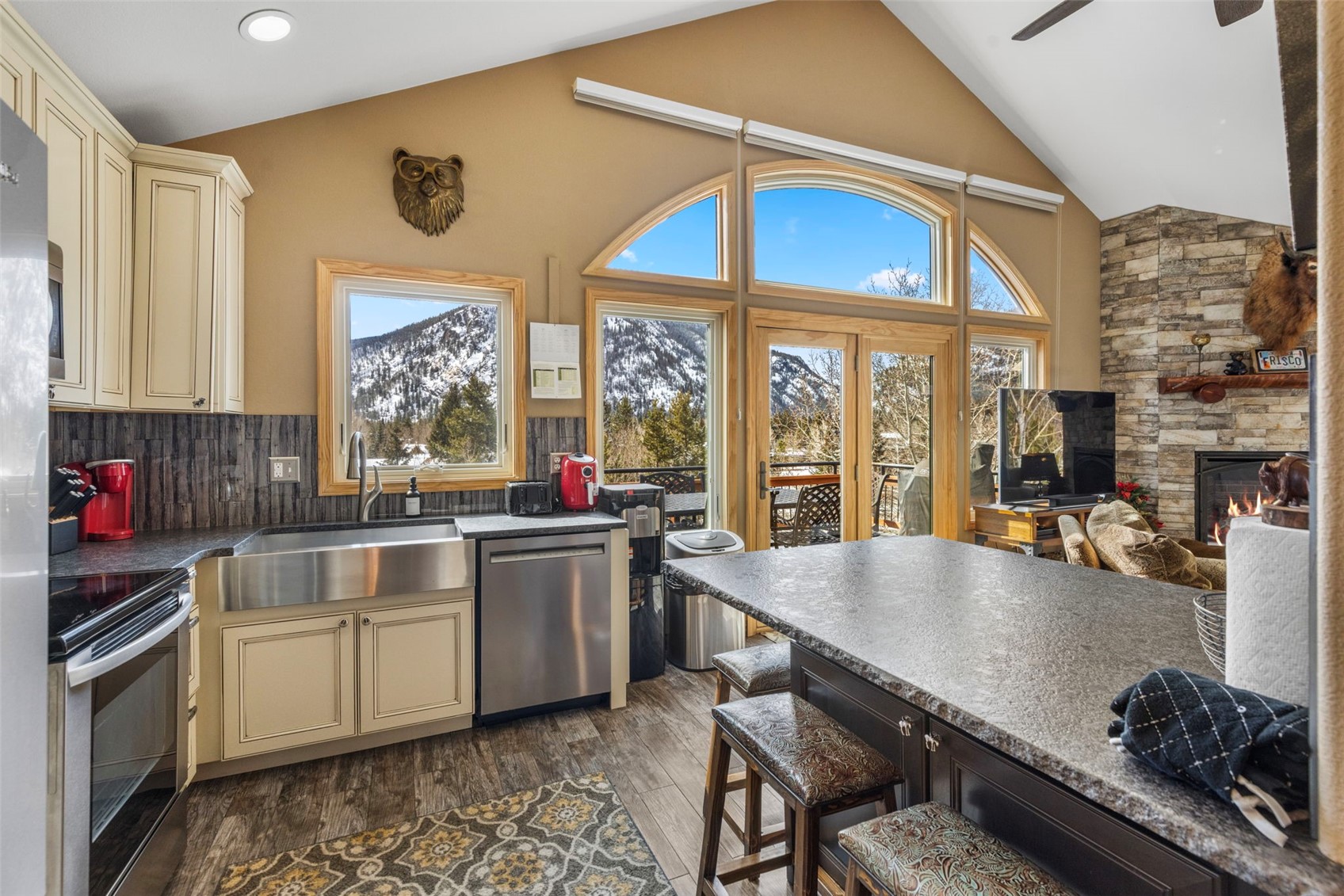 14 Larson Lane, Unit B Frisco, CO 80443 - Photo 9 of 40 a kitchen with a table chairs stove and cabinets