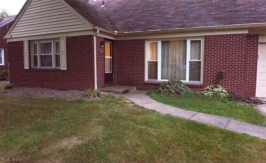 6714 Trenholm Road Youngstown, OH 44512 - Photo 21 of 22 View of exterior entry featuring a lawn