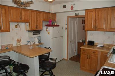 214 East Garrison Street Bethlehem, PA 18018 - Photo 8 of 11 a kitchen with stainless steel appliances granite countertop a refrigerator and a stove top oven
