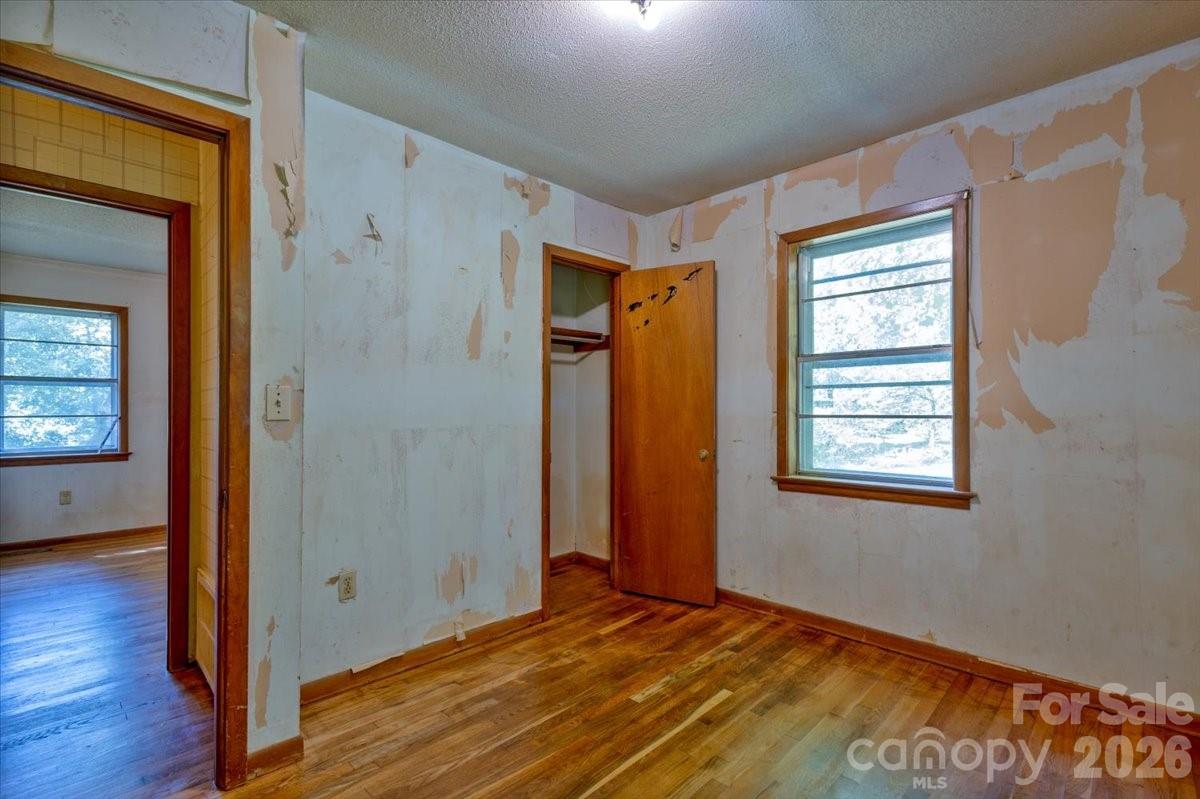 156 Old Sweetwater Road Robbinsville, NC 28771 - Photo 21 of 25 a view of an empty room with wooden floor and a window