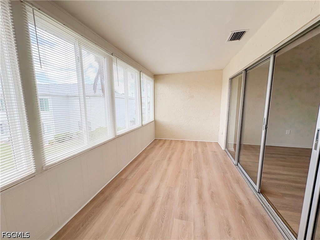 1830 Brantley Road, Unit I7 Fort Myers, FL 33907 - Photo 28 of 34 a view of an empty room with wooden floor and a window