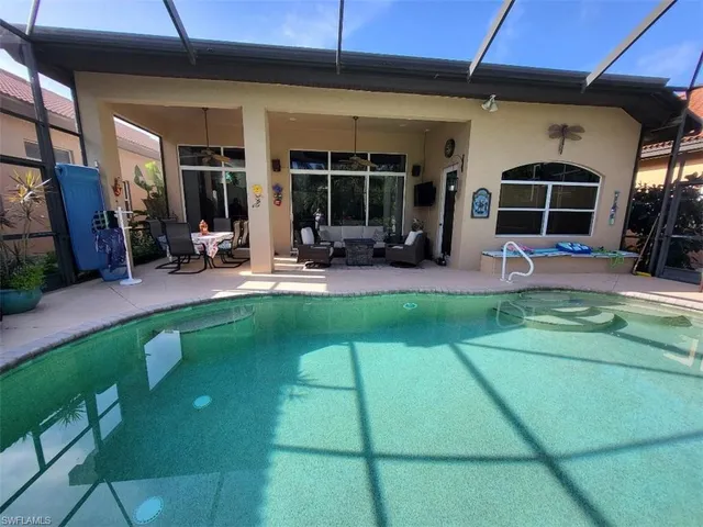 a view of a house with backyard porch and sitting area