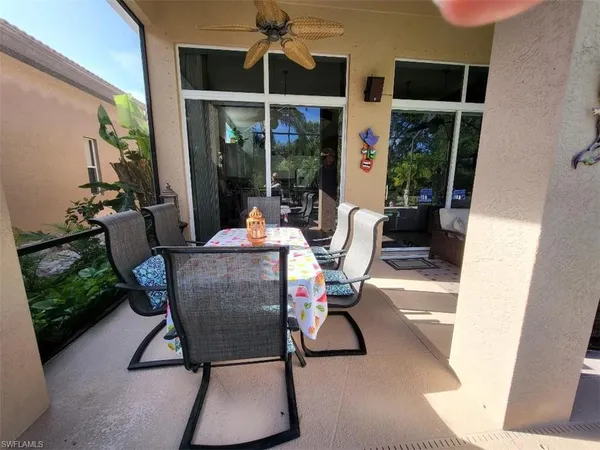 a view of a patio with table and chairs and potted plants