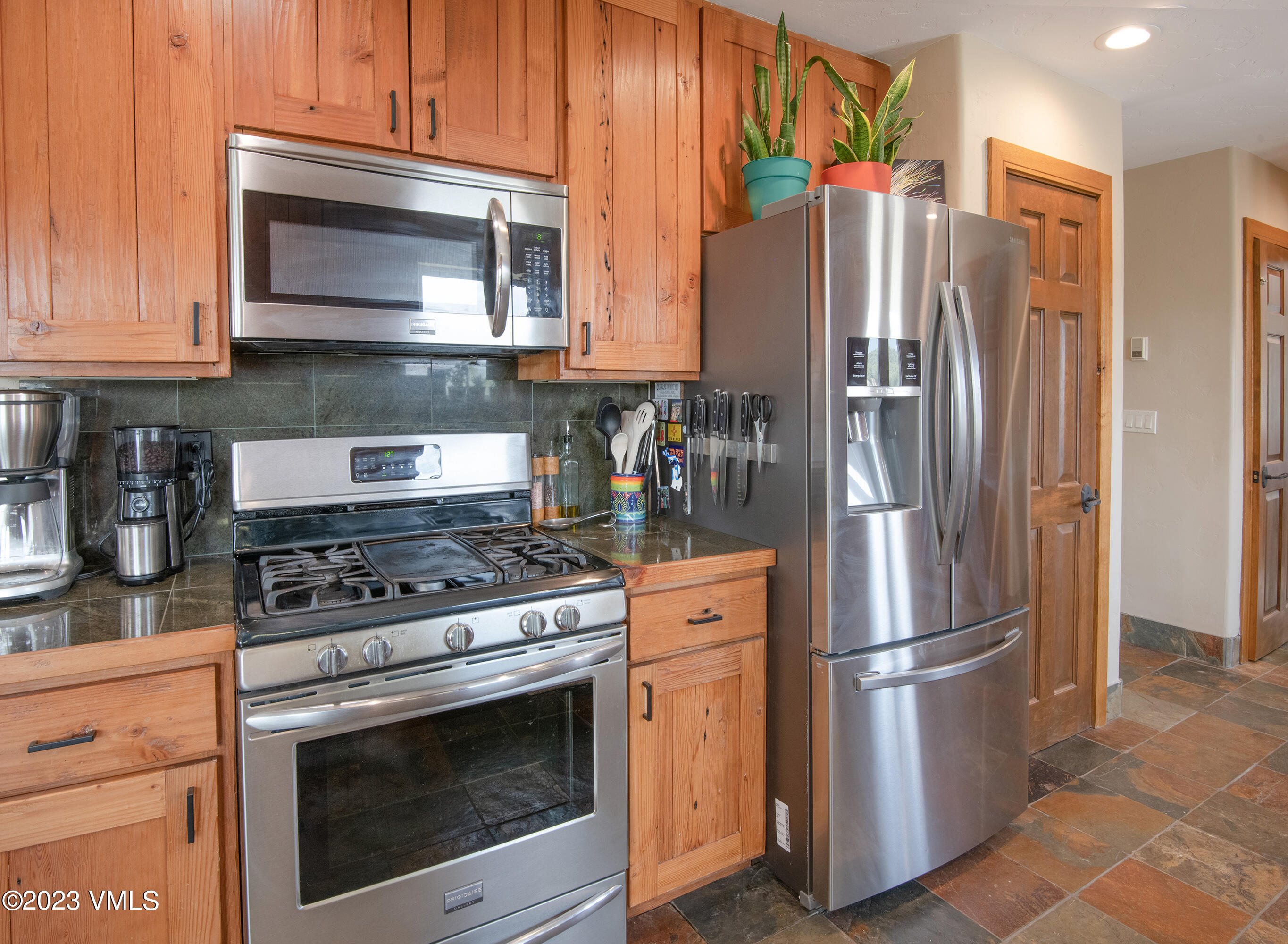 686 Mesa Drive Eagle, CO 81631 - Photo 15 of 73 a kitchen with stainless steel appliances granite countertop a stove a refrigerator and a microwave