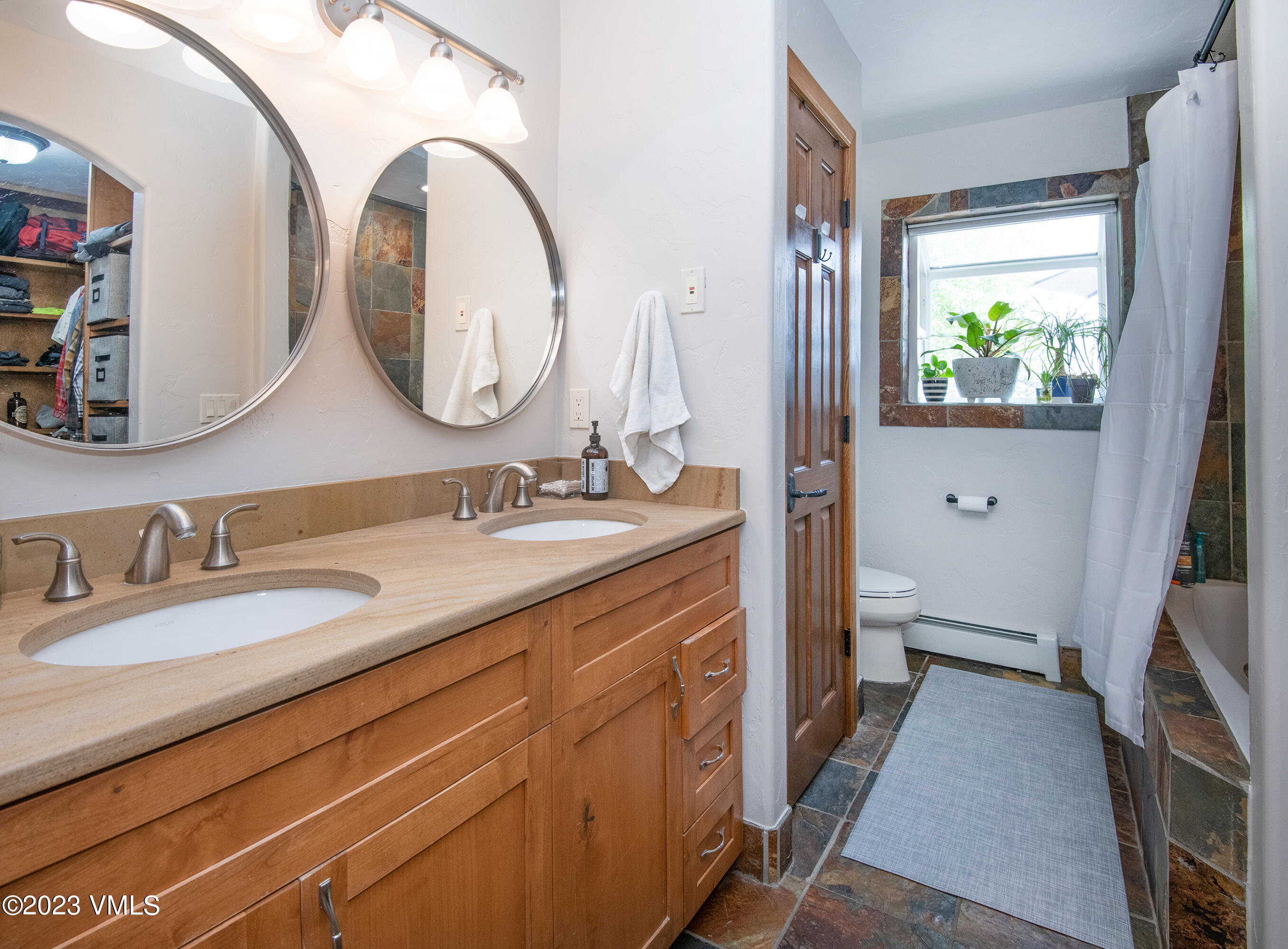 686 Mesa Drive Eagle, CO 81631 - Photo 28 of 73 a spacious bathroom with a granite countertop sink a mirror and a toilet