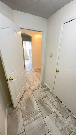 a view of a refrigerator in kitchen and utility room