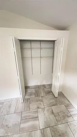 a view of a livingroom with wooden floor and a window