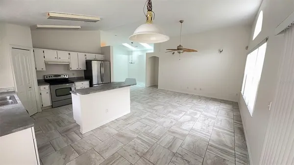 a view of a kitchen with a sink stainless steel appliances and cabinets