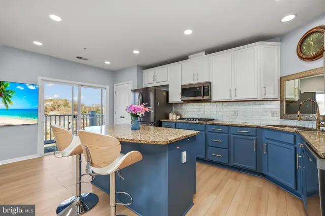 a kitchen with microwave a stove and cabinets