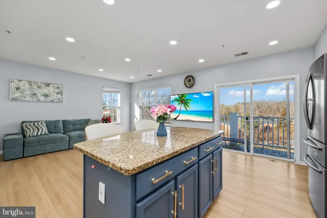 a kitchen with granite countertop a table and chairs