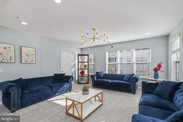 a living room with furniture ceiling fan and a window
