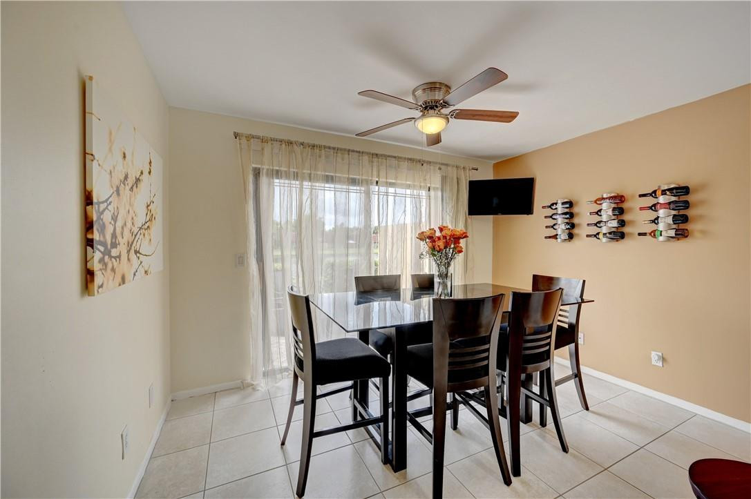 8129 Boca Rio Drive Boca Raton, FL 33433 - Photo 13 of 39 a view of a dining room with furniture and a large window