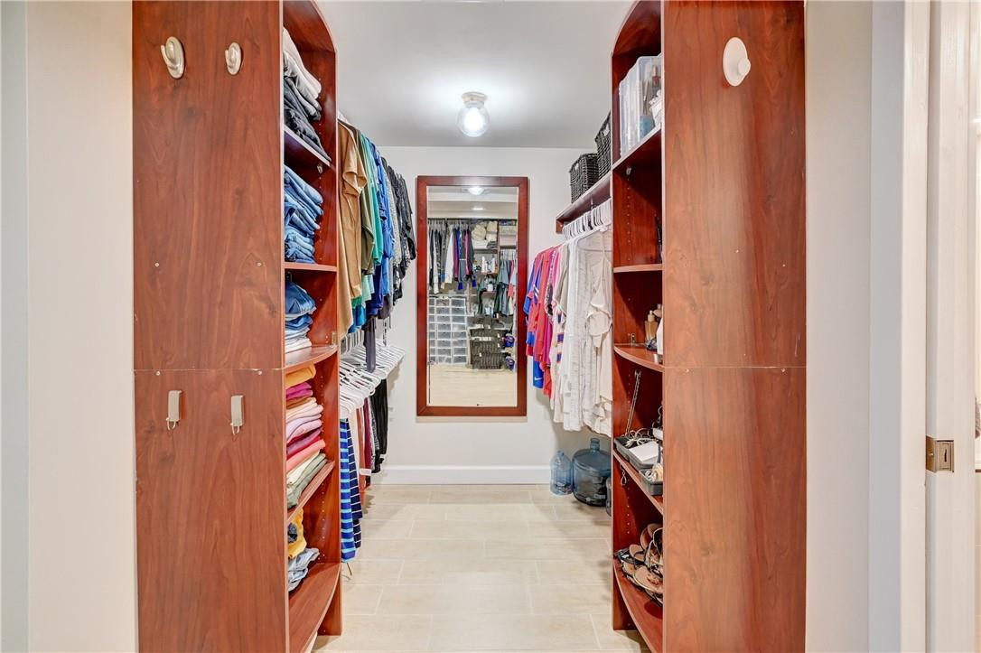 8129 Boca Rio Drive Boca Raton, FL 33433 - Photo 17 of 39 a view of walk in closet with clothes