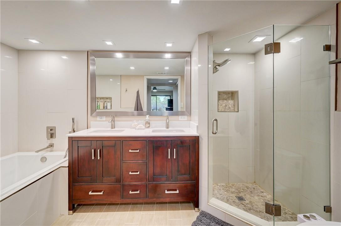 8129 Boca Rio Drive Boca Raton, FL 33433 - Photo 19 of 39 a spacious bathroom with a granite countertop sink a mirror and a shower
