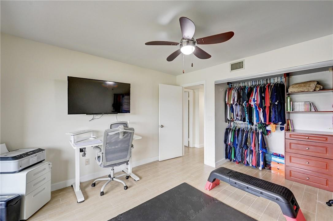 8129 Boca Rio Drive Boca Raton, FL 33433 - Photo 24 of 39 a view of a livingroom with workspace and a flat screen tv