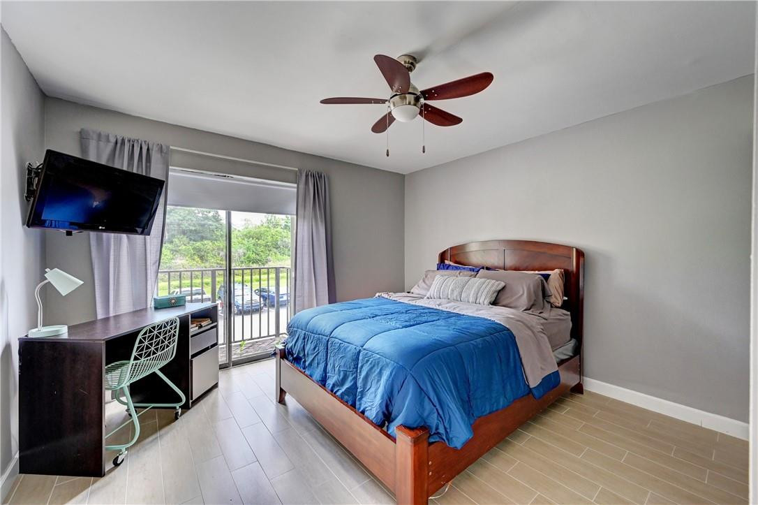 8129 Boca Rio Drive Boca Raton, FL 33433 - Photo 27 of 39 a bedroom with a bed a window and a flat screen tv