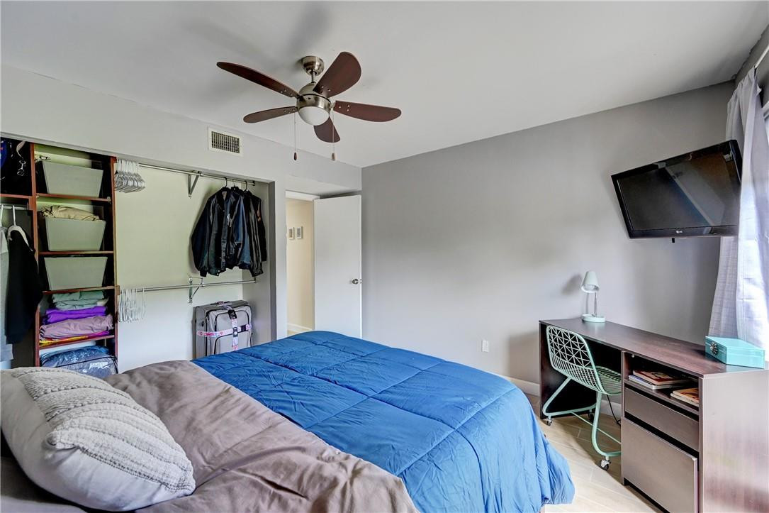 8129 Boca Rio Drive Boca Raton, FL 33433 - Photo 28 of 39 a bedroom with a bed and a flat screen tv