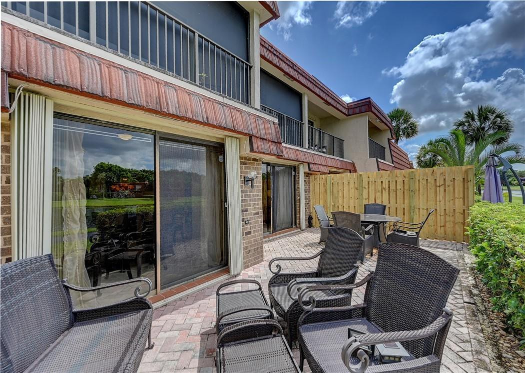 8129 Boca Rio Drive Boca Raton, FL 33433 - Photo 32 of 39 a view of a patio with table and chairs and potted plants