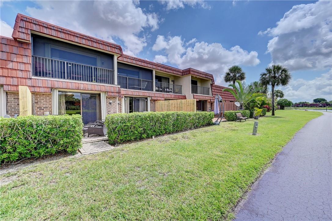 8129 Boca Rio Drive Boca Raton, FL 33433 - Photo 33 of 39 a view of a building with a yard