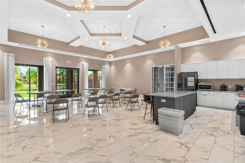 8129 Boca Rio Drive Boca Raton, FL 33433 - Photo 38 of 39 a large room with lots of tables and chairs