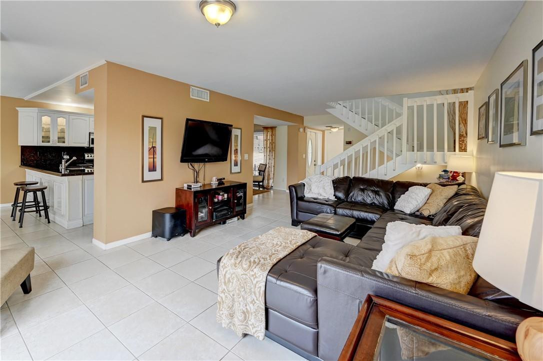 8129 Boca Rio Drive Boca Raton, FL 33433 - Photo 6 of 39 a living room with furniture and a flat screen tv