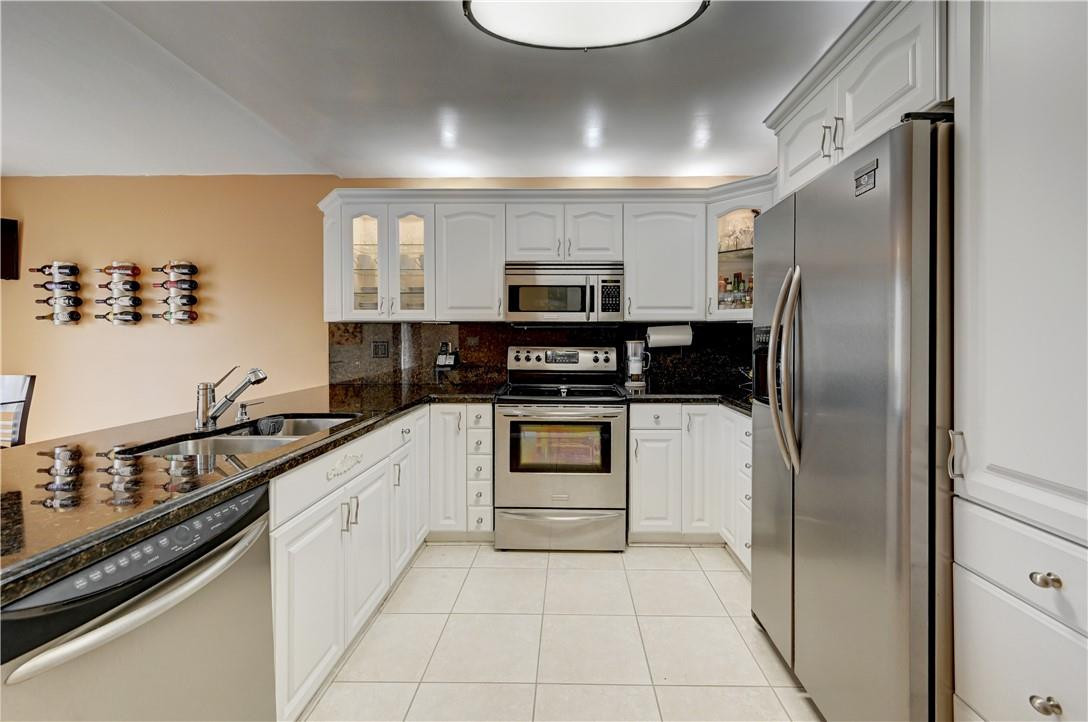 8129 Boca Rio Drive Boca Raton, FL 33433 - Photo 10 of 39 a kitchen with stainless steel appliances granite countertop a refrigerator and a stove