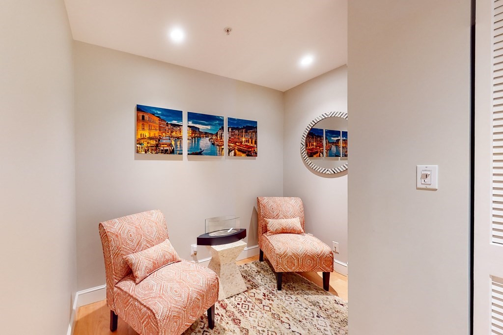 550 Pleasant Street, Unit 208 Winthrop, MA 02152 - Photo 16 of 32 a living room with furniture and a wall painting
