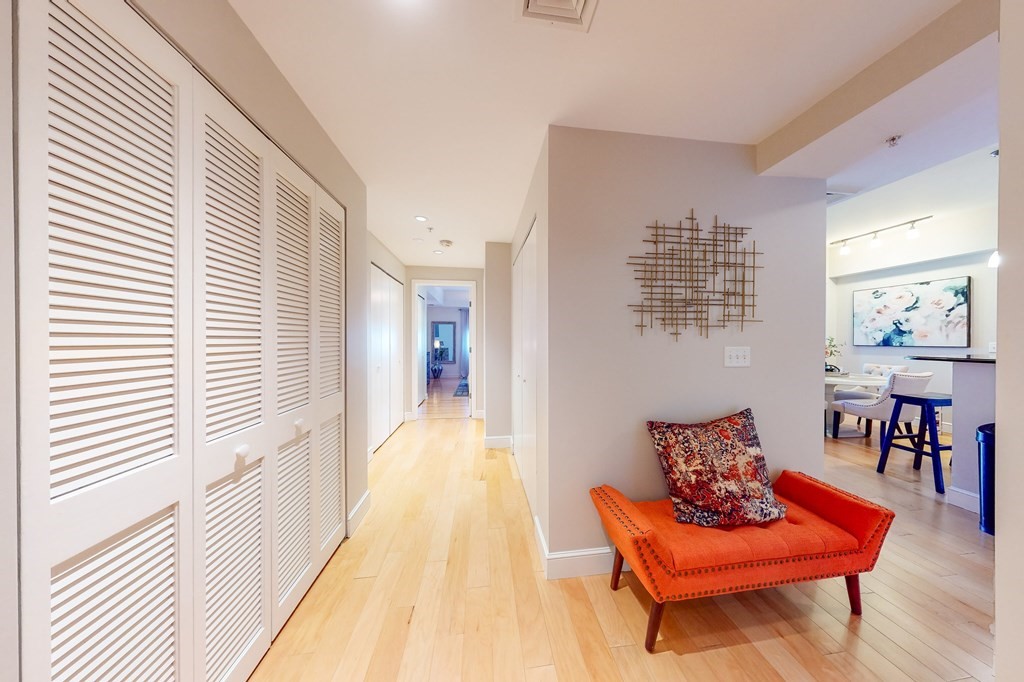 550 Pleasant Street, Unit 208 Winthrop, MA 02152 - Photo 17 of 32 a hallway with wooden floor and a potted plant