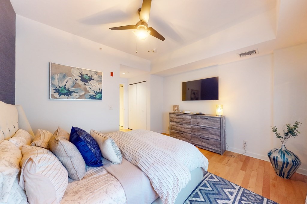 550 Pleasant Street, Unit 208 Winthrop, MA 02152 - Photo 22 of 32 a bedroom with a bed and a flat screen tv