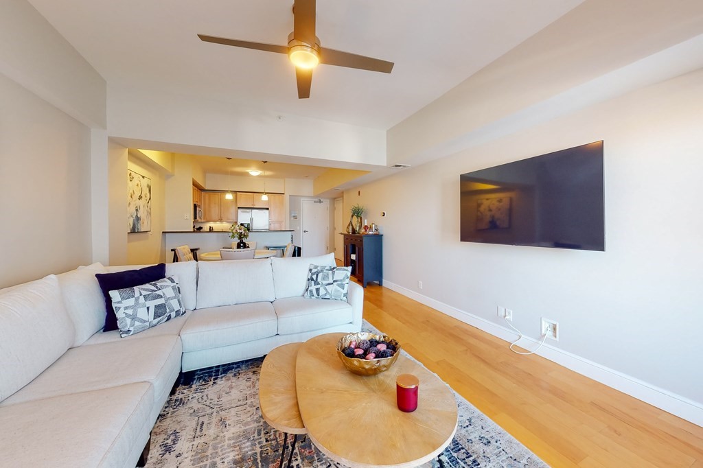 550 Pleasant Street, Unit 208 Winthrop, MA 02152 - Photo 3 of 32 a living room with furniture and a flat screen tv