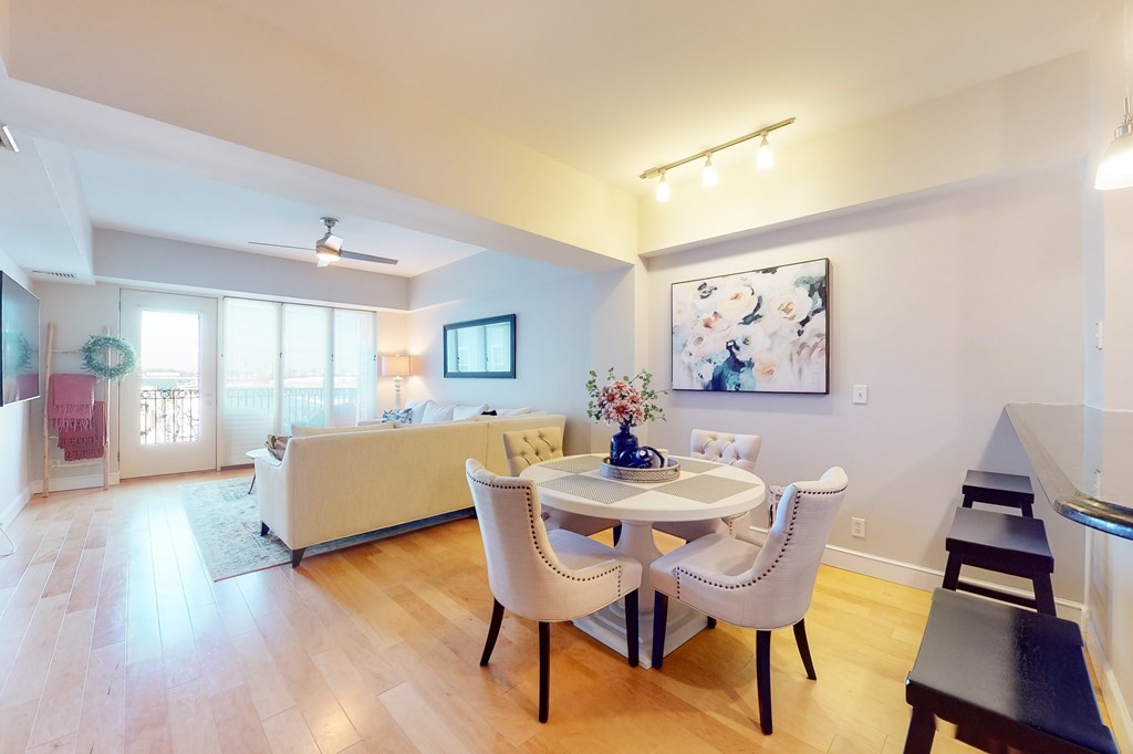 550 Pleasant Street, Unit 208 Winthrop, MA 02152 - Photo 8 of 32 a view of a dining room with furniture and wooden floor