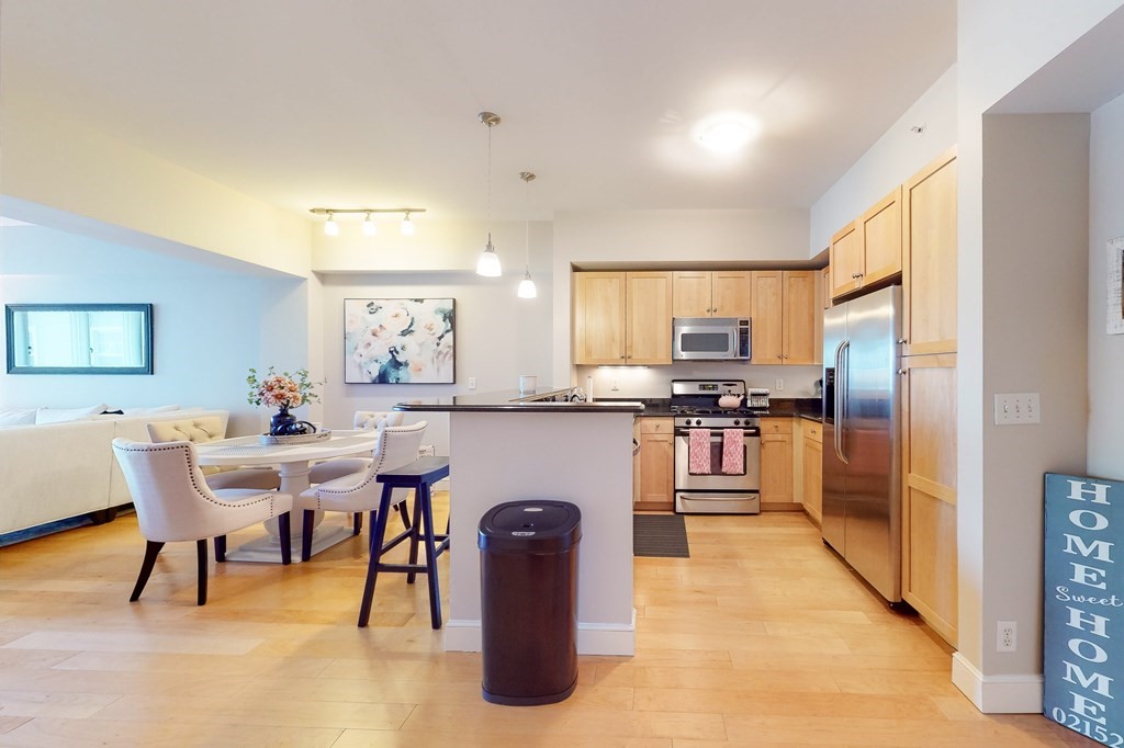 550 Pleasant Street, Unit 208 Winthrop, MA 02152 - Photo 10 of 32 a kitchen with cabinets and chairs