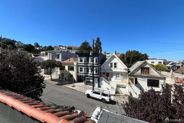 a front view of a house with a view of a yard