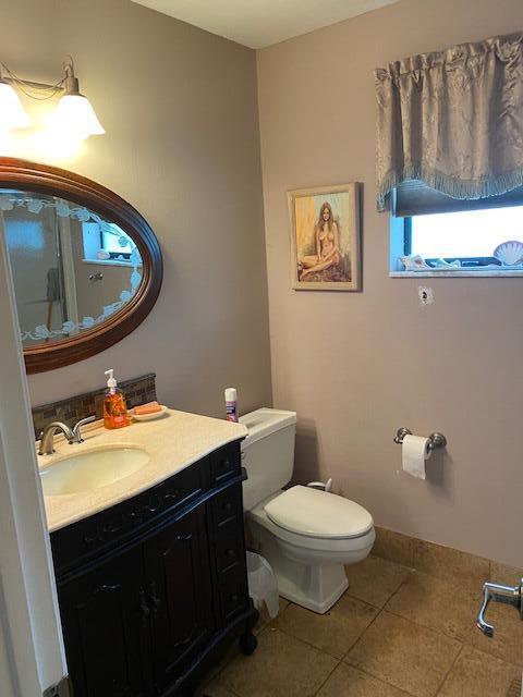 7848 Beechfern Circle, Unit 39 Tamarac, FL 33321 - Photo 11 of 19 a bathroom with a toilet a sink and mirror