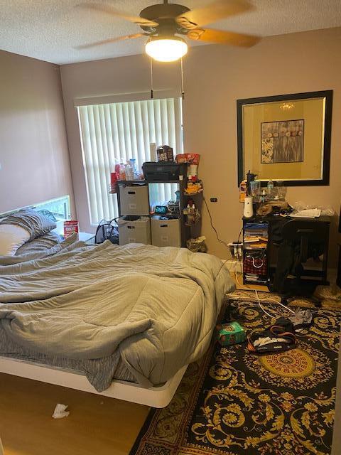 7848 Beechfern Circle, Unit 39 Tamarac, FL 33321 - Photo 13 of 19 a bedroom with a bed and wooden floor