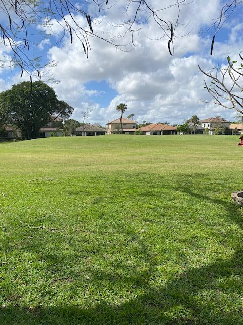 7848 Beechfern Circle, Unit 39 Tamarac, FL 33321 - Photo 17 of 19 a view of a big yard with a table and chairs