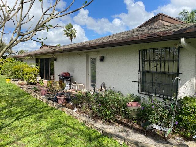 7848 Beechfern Circle, Unit 39 Tamarac, FL 33321 - Photo 2 of 19 a view of a house with potted plants and a bench