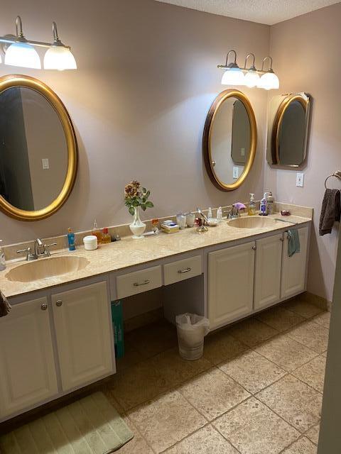 7848 Beechfern Circle, Unit 39 Tamarac, FL 33321 - Photo 5 of 19 a bathroom with a double vanity sink and a mirror