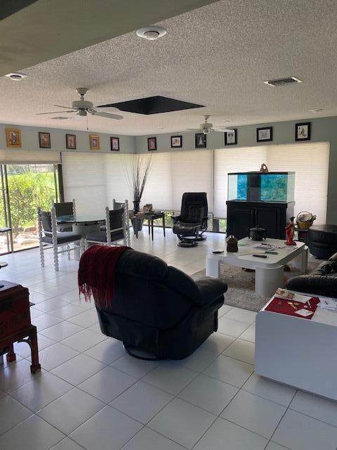 7848 Beechfern Circle, Unit 39 Tamarac, FL 33321 - Photo 7 of 19 a living room with furniture and a flat screen tv
