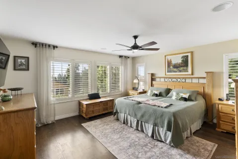 a bedroom with a bed and a large window