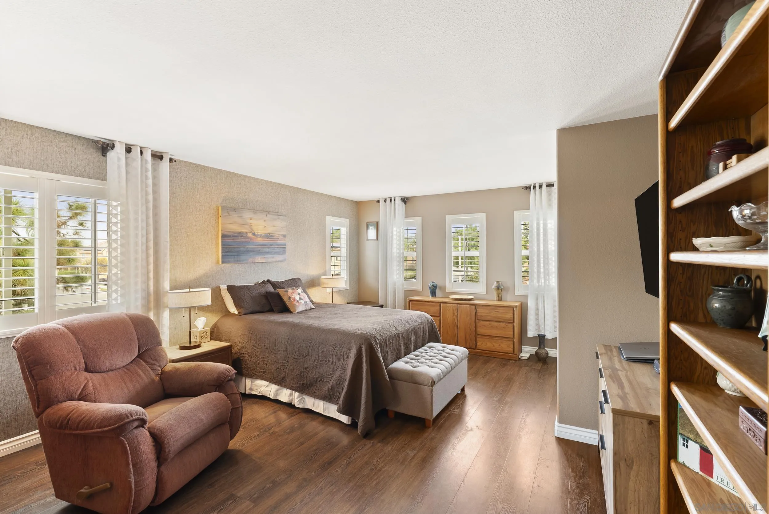 1802 Webber Way Chula Vista, CA 91913 - Photo 30 of 52 a spacious bedroom with a bed couch and a large window